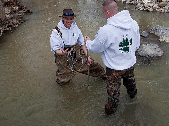 Students wading in stream