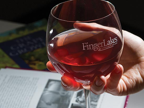 Student holding glass of red wine