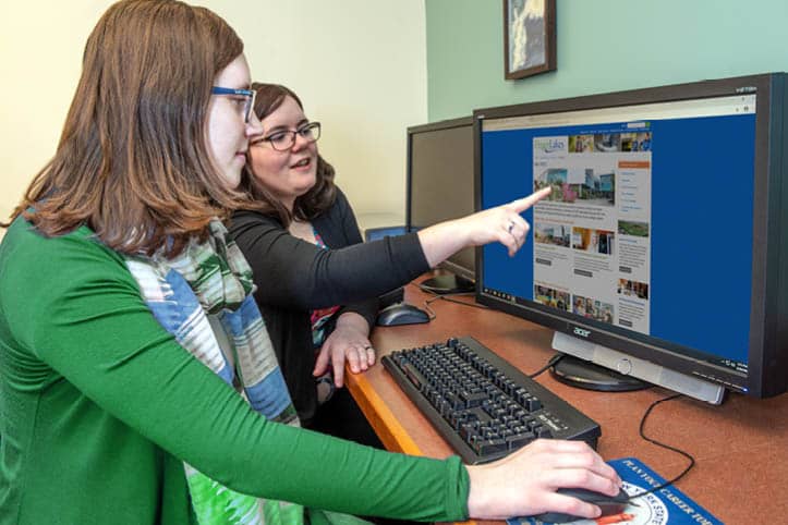 Admissions Counselor helping a student request information from the FLCC website.