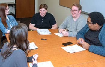 Members of Student Corporation sit around a table, making decisions about life at FLCC.