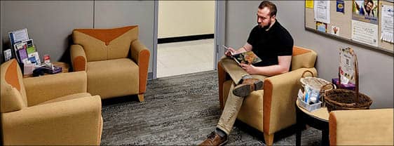 A student sitting in the Center for Student Well-Being, waiting for an appointment.