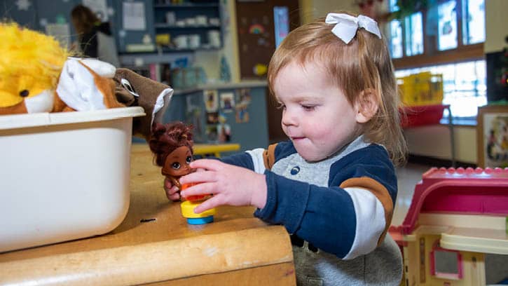 A toddler playing with toys.