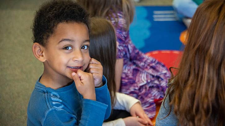 Several preschool age children enjoying a large group activity.