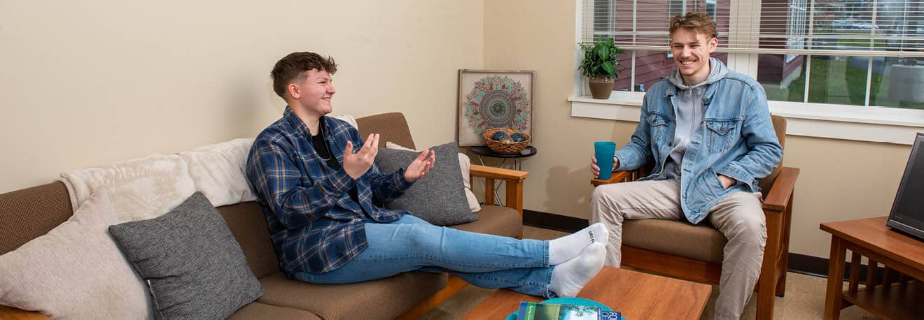 Two students hanging out in the FLCC student housing complex, the Suites at Laker Landing.