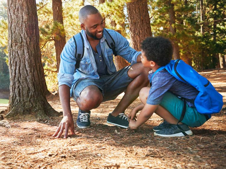 A father and son enjoy a peaceful moment together during a nature walk.