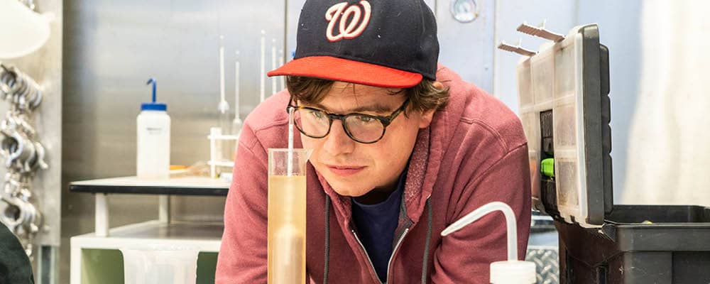 A Viticulture student records an enology measurement using winemaking equipment at the FLCC Viticulture and Wine Center.